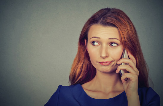 Annoyed upset woman talking on mobile phone