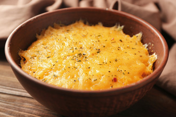 Corn porridge in plate and napkin on wooden background, closeup