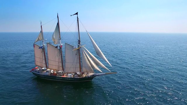 Tall ship at sea, majestic vessel sailing in open waters in good weather.

