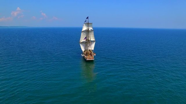 Tall ships at sea, majestic vessels sailing in open waters in good weather.
