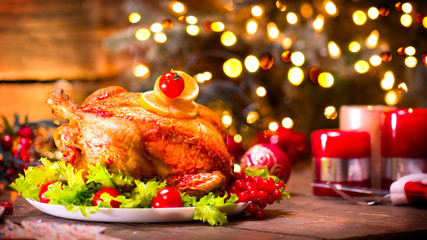 Fototapeta na wymiar Christmas holiday family dinner. Decorated table with roasted turkey, Christmas tree