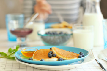 Tasty pancakes with blueberry on plate