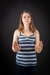 Beautiful woman doing different expressions in different sets of clothes: stop sign