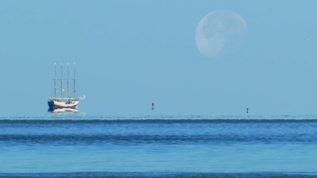 Ghostly tall ship seems to hover above the water&rsquo;s surface, mirage, illusion.
