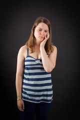 Beautiful woman doing different expressions in different sets of clothes: toothache