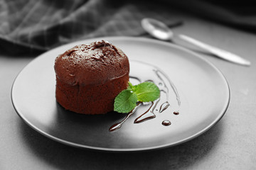 Chocolate fondant with mint on plate