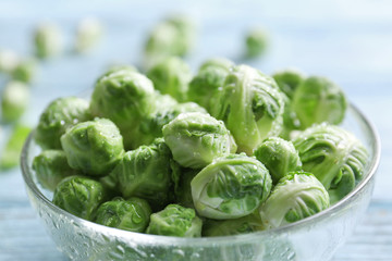 Brussels sprouts in glass bowl on wooden table