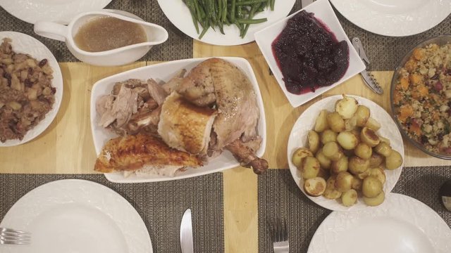 Overhead footage of Thanksgiving table with turkey bing served