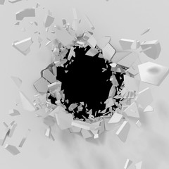 Cracked explosion hole with fragments in white wall