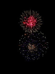 Fototapeta premium Brightly Colorful Fireworks isolated black background. New Year celebration fireworks.