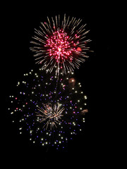 Fototapeta premium Brightly Colorful Fireworks isolated black background. New Year celebration fireworks.