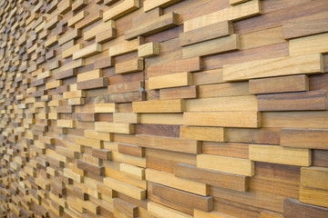 exposed wooden wall exterior, patchwork of raw wood forming a beautiful parquet wood pattern.(selected focus)