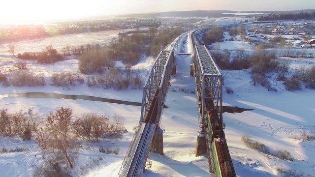 Top view of freight train with carriages on railways at winter
