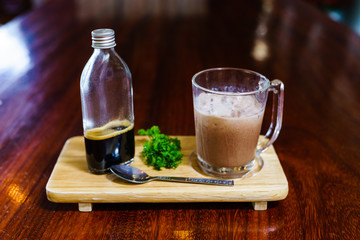 ice mocca on wood table. ice cocoa with espesso in glass for mix to mocca coffeee.