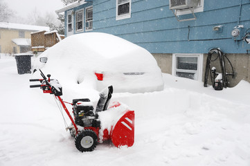 snow blower on the driveway for snow removal after blizzard 