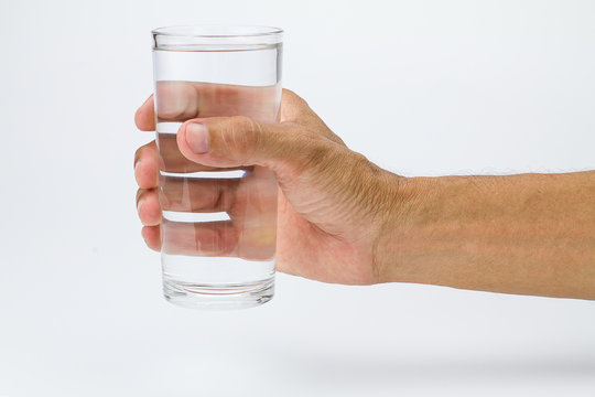 Man hand holding glass of full water on white background