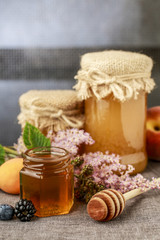 Obraz na płótnie Canvas Jar of honey and autumn fruits.