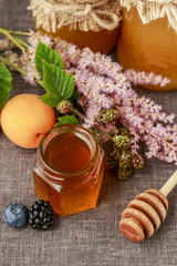 Jar of honey and autumn fruits.