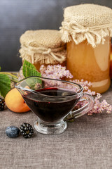 Jar of honey and autumn fruits.