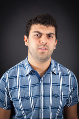 Handsome man doing different expressions in different sets of clothes: angry