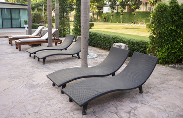 Relaxing rattan chairs beside swimming pool