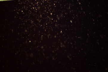Snow falling from the night sky