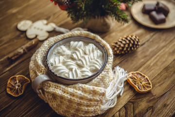 Hot cocoa with marshmallows  spices on the old wooden boards.