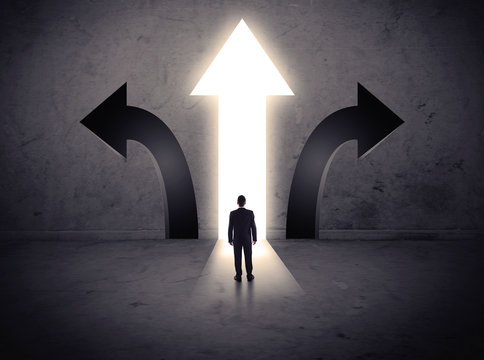 Businessman in front of three arrows