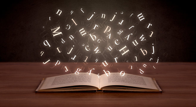 Alphabet letters over book