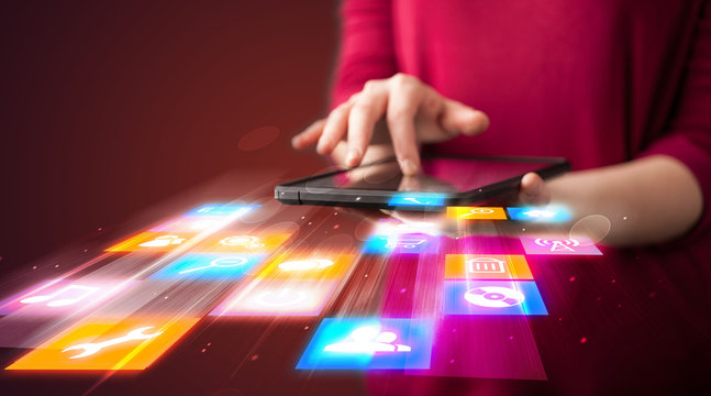 Hand holding tablet device with media application