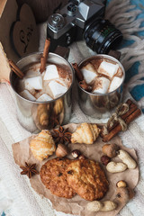 Metal mugs with cacao and marshmallows