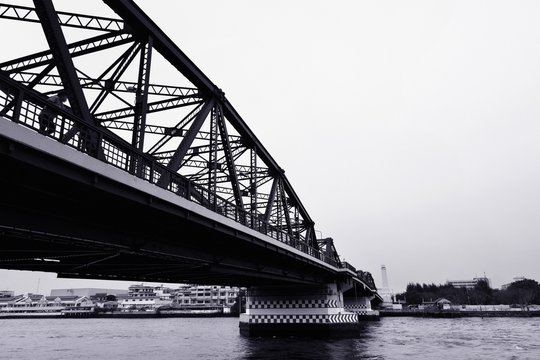 Fototapeta Black and white bridge across a Chao Phraya river   