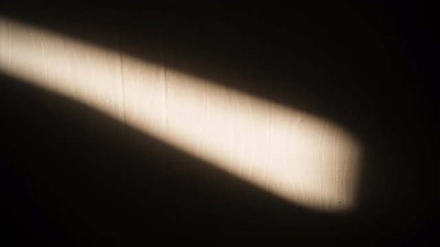 Entering window light with changing ray on the wall
