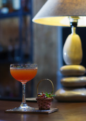 alcoholic cocktail with cherry on the bar