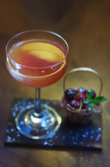 alcoholic cocktail with cherry on the bar