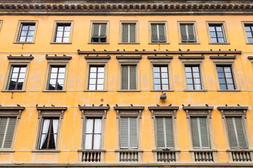 yellow facade of old apartment house in Florence