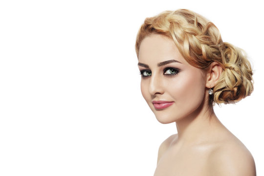 Portrait of young beautiful blonde woman with stylish prom hairdo over white background