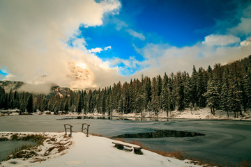 Alpine lake in front of Tre Cime di Lavaredo in a winter evening