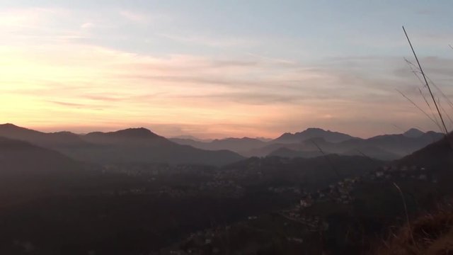 Fiery sunset from mountain pick with thin glazes in the sky evening. Fall season. Orobie alps. The summit of Mount Rena. Bergamo Italy. 