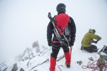 Fototapeta na wymiar Alpinists in mountains. Team work.
