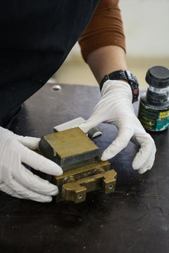 Engineer preparing a soil sample in a mold for direct shear laboratory test