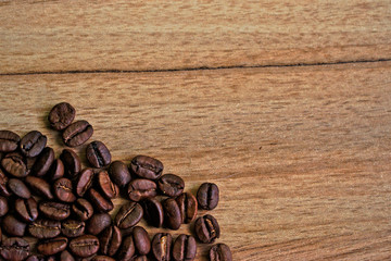 Fototapeta premium Coffee beans on a wooden table