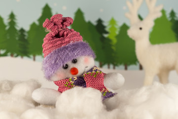 Happy snowman in winter forest.