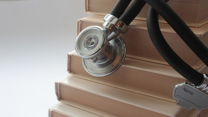 books on the table and they have a device for listening to internal organs of the body