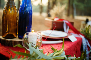 Table with candles in the forest