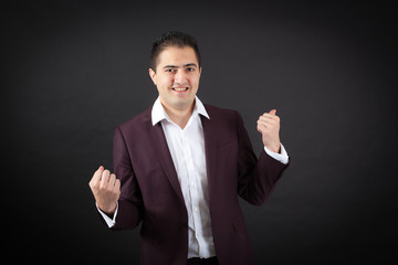 Handsome man doing different expressions in different sets of clothes: arms raised