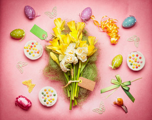 Easter flat lay with spring flowers, eggs and cakes, top view