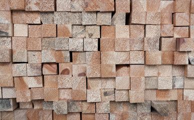 Background of ends of square section wooden pine sticks.