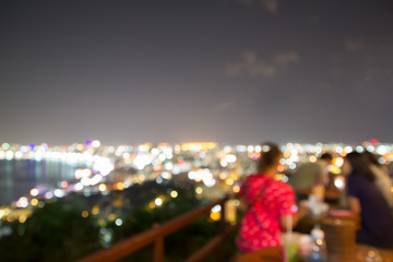 Obraz premium abstract blur focus 2 lady eat and look view pattaya at night