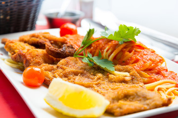 close-up of plate of pasta and chicken with lettuce